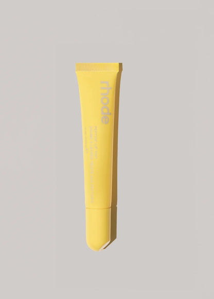 Yellow tube of cream on a gray background